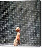 A Boy Standing Beside A Wall Fountain Canvas Print