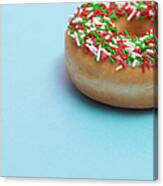 A Donut With Sprinkles On A Blue Canvas Print