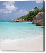 A White Sand Beach With Turqouise Water And Stones Canvas Print