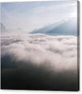 Aerial View Of Low Clouds And Mountain Peak At Sunrise Canvas Print