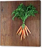 Bunch Of Baby Carrots Laying On Wooden Canvas Print