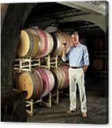 Businessman Holding Wine Glass In Cellar Canvas Print