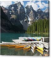 Canoes Around A Dock On A Lake With Canvas Print