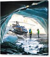 Couple Approaches Helicopter After Exploring Ice Cave. Canvas Print