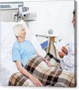 Doctor Talking To Senior Woman On Hospital Ward Canvas Print
