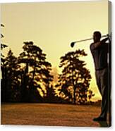 Golfer Swinging Club On Golf Course At Canvas Print