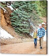 Grandfather And Granddaughter Holding Hands On A Walk In The Mountains Canvas Print