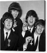 The Beatles Holding Medals Canvas Print