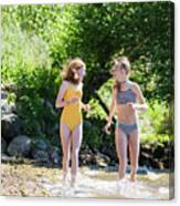 Two Happy Tween Teen Girls In Swimsuits Running On Lake Shore