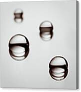 Water Droplets On A Reflective Surface Canvas Print