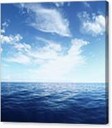 Wispy Clouds Over Deep Blue Ocean Canvas Print
