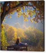 Woman Sitting On A Bench Under A Tree And Facing A Yellow Autumn Canvas Print
