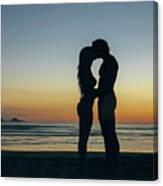 Young Couple Kissing On The Beach Canvas Print
