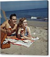 Young Couple Lying On Beach With Beer Canvas Print