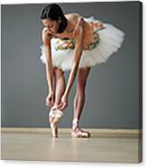 Young Female Ballerina Adjusting Ballet Canvas Print
