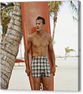 Young Man Holding Surfboard On Beach Canvas Print