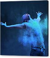 Young Man In Spray Of Colored Powder Canvas Print