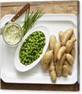Fingerling potatoes and spring peas served with a chive compound butter Canvas Print