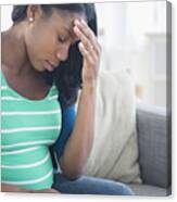Anxious Black Pregnant Woman Rubbing Forehead On Sofa Canvas Print
