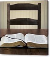 Bible Sitting Open On A Table In Front Of An Empty Chair Canvas Print