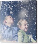 Brother And Sister Looking Out Window At Snow Canvas Print