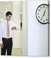 Businessman Checking Watch In Office By Clock Canvas Print
