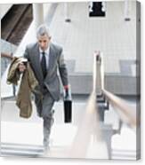 Businessman Walking Up Stairs In Train Station Canvas Print