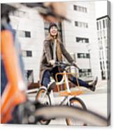 Carefree Woman With Man Riding Bicycle In The City Canvas Print