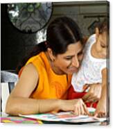 Close Up Of A Mother Teachinh Her Child To Read Canvas Print