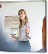 Confident Businesswoman Giving Presentation To Colleagues In Office Canvas Print