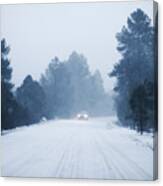 Defocused Car Driving In Snow Along Rural Road Canvas Print