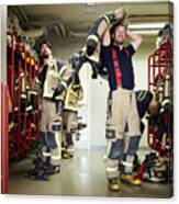 Firefighters Wearing Protective Workwear In Locker Room While Looking Up At Fire Station Canvas Print