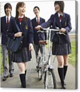 Four Students In Uniform Walking Outdoors, One Holding A Bicycle Canvas Print