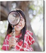 Girl Using Magnifying Glass Outdoors Canvas Print
