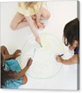 Girls Sitting On Floor Drawing Globe Together Canvas Print