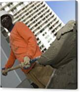 Low Angle View Of A Male Construction Worker Shoveling Cement Canvas Print
