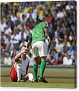 Male Soccer Player Assisting Opponent After Tackle, In Stadium Canvas Print