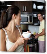 Man And Woman Preparing Breakfast And Smiling At One Another Canvas Print