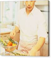 Man In Kitchen Preparing Food Canvas Print