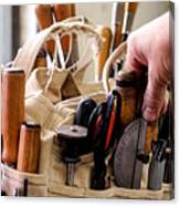 Man Selecting A Hand Tool From A Bag On Workbench Canvas Print