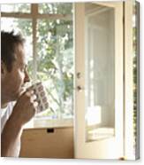 Man Sitting Indoors, Drinking Cup Of Coffee, Side View Canvas Print