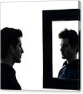 Man Staring At His Own Reflection In Mirror Canvas Print