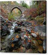 Medieval Stoned Bridge With Water Flowing In The River In Autumn. Canvas Print
