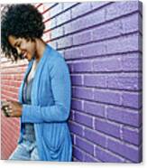 Mixed Race Woman With Cell Phone Standing By Colorful Wall Canvas Print