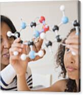 Mother And Daughter Examining Molecular Model Canvas Print