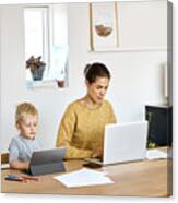 Mother And Son Using Technologies At Home Canvas Print