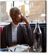 Pensive Woman Sitting By Herself In A Restaurant At Lunch Break Canvas Print