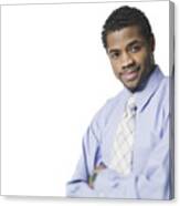 Portrait Of A Young Adult Male In A Blue Shirt And Tie As He Folds His Arms And Smiles Canvas Print