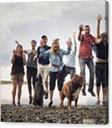 Portrait Of Adult Family With Dogs Jumping On Shingle Beach, Maine, Usa Canvas Print
