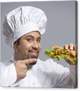 Portrait Of Chef Pointing At Sandwich Canvas Print